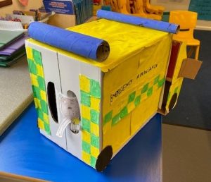 Back of large yellow handmade cardboard ambulance 